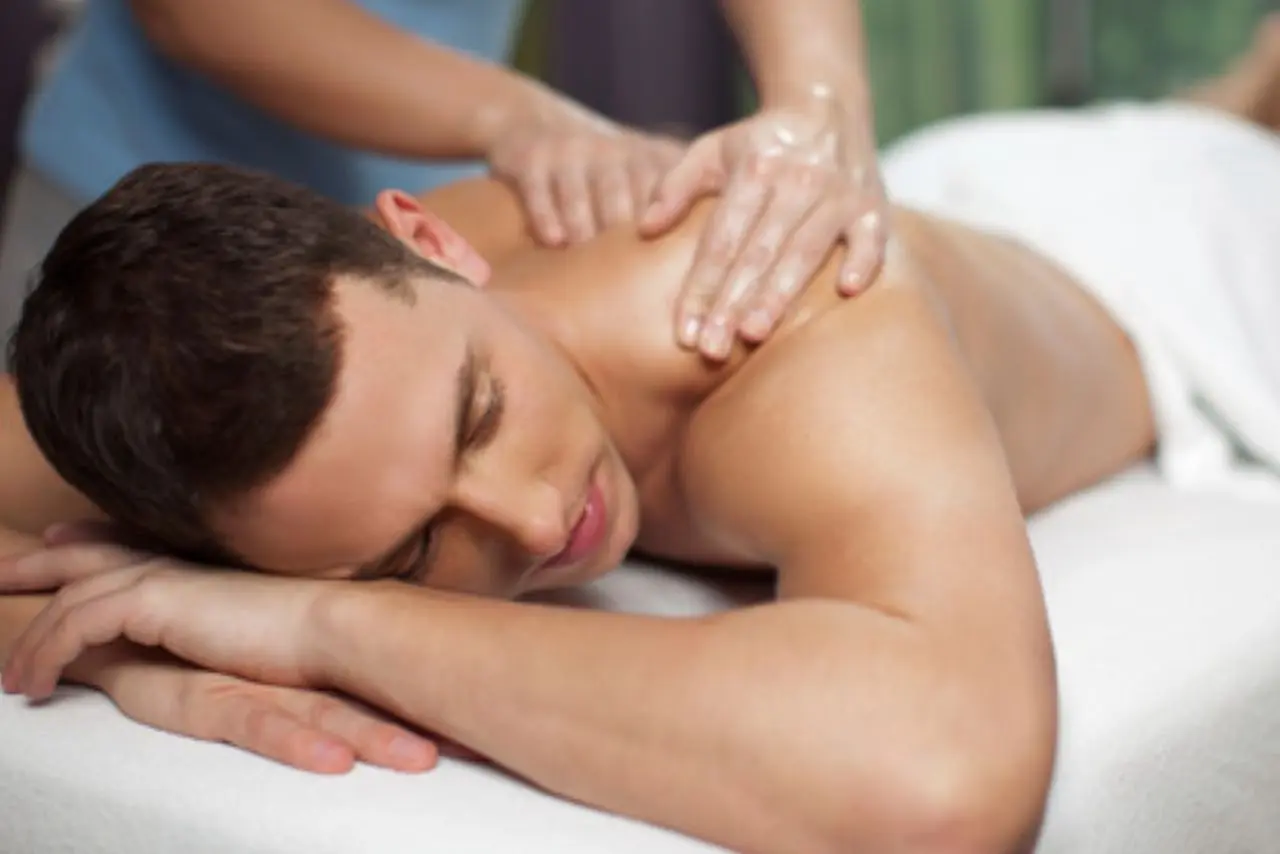 Close-up of the Best Balinese Massage in Thane, showing warm lighting and strong but gentle hand pressure on the back for deep body relaxation.